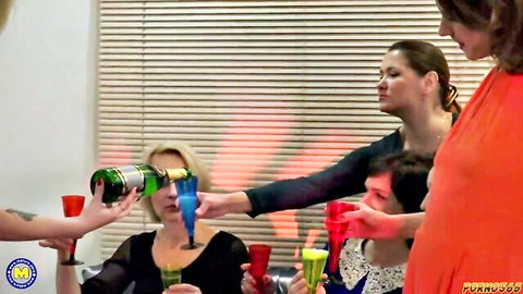 Group of mature MILFs drinking and partying in lively social scene