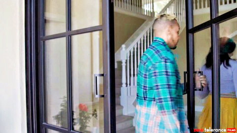 Couple in casual attire at glass door, teasing encounter from Zero Tolerance
