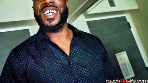 Handsome BBC bull with beard smiles confidently in polka dot shirt for wife sharing site