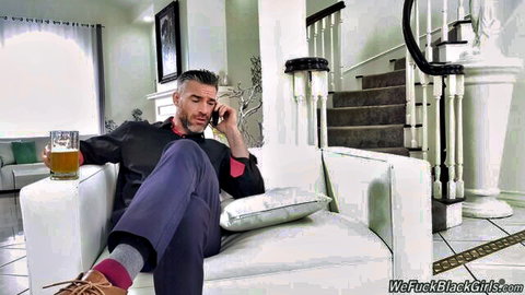 Handsome mature white guy in suit sits on couch holding beer while calling black pussy for interracial fuck