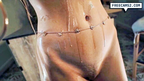 Wet oiled blonde bombshell glistening nude body closeup