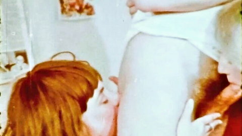 Retro redhead cheerleader kissing muscular man's torso in vintage xxx scene