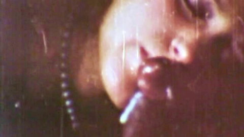 Seductive retro woman smoking cigarette in vintage porn close-up
