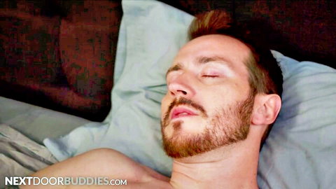 Shirtless redhead bearded man relaxing in bed, soccer player vibe