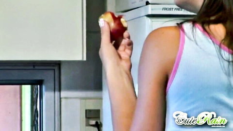 Latina teen in tank top biting apple in kitchen, Milfed studio