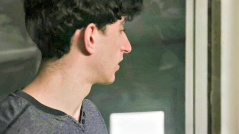 London River's male co-star, curly-haired stud in gray shirt, side profile view