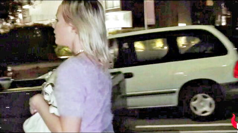 Natalia Queen in fuzzy purple sweater near car at night