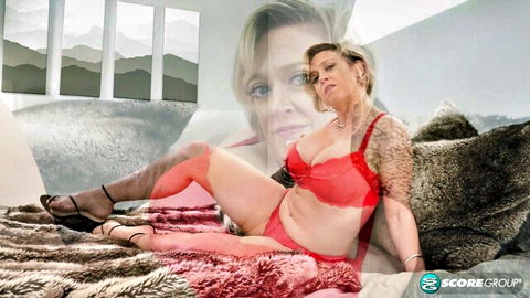 Dee Williams in red lingerie, seductive pose on bed