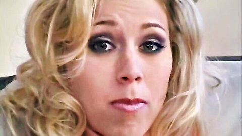 Close-up of surprised blonde beauty with wavy hair and bold makeup