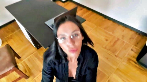 Brunette MILF secretary with glasses and big tits cleavage looking down POV in office