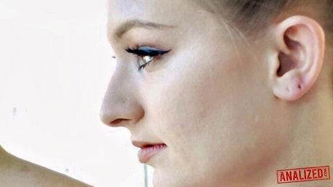 Close-up profile of sexy blonde with parted lips and sultry eyes teasing blowjob readiness
