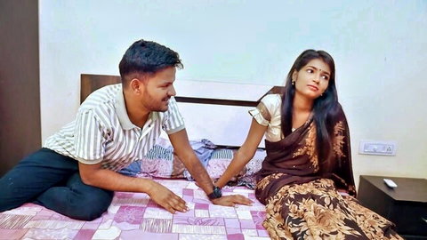 Indian couple in saree and shirt intimate moment on bed