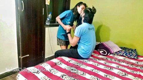 Desi Indian teen in blue uniform kissing guy passionately on bed