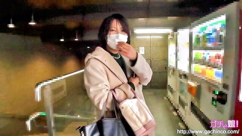Japanese amateur woman in coat and mask at vending machine