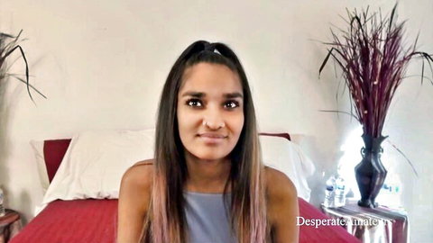 Sexy South Asian amateur with long hair smiling in low-cut gray tank top showing cleavage