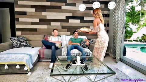 Curvy blonde MILF in dress serves pie to two guys on couch before swinger foursome