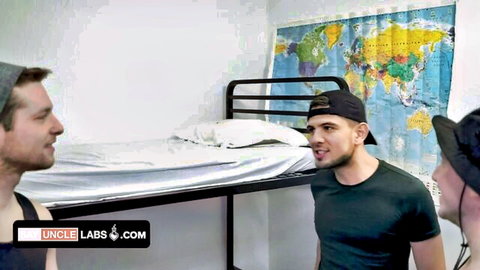 Three fit young frat bros in casual clothes prank in dorm, teasing tension builds