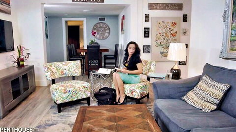 Crystal Rush in green skirt and black top, sitting seductively with notebook