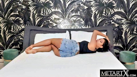 Sexy Latina lying seductively in denim shorts and crop top
