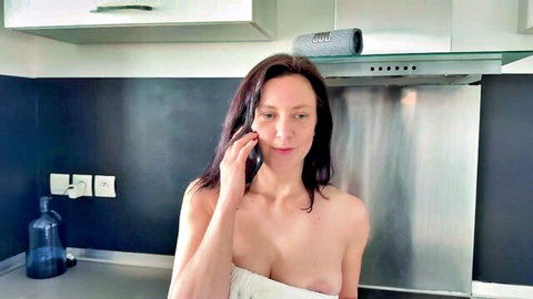 Lily Rose topless in kitchen, smiling on phone, bare breasts exposed