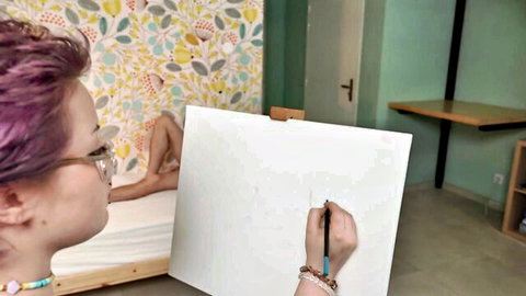 Purple-haired artist with glasses sketches nude model in succubus fantasy
