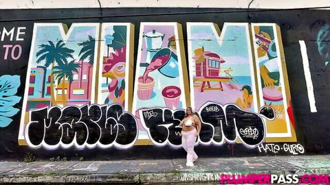 Veronica Jasmine voluptuous curves in white outfit at Miami graffiti mural