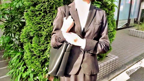 Tempting Asian businesswoman in elegant brown suit posing outdoors