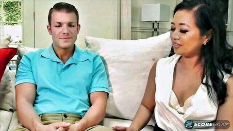 Lucky Starr teases with cleavage beside guy on couch interview