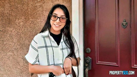 Madison Wilde smiling in checkered shirt and glasses outside