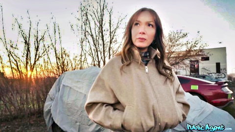 Paola Guerra posing sexily outdoors in beige coat at sunset