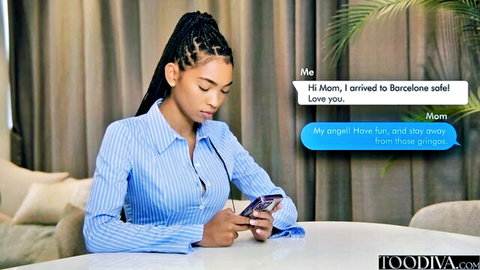 Barbie Rous, ebony beauty with braids in blue shirt texting mom from Barcelona
