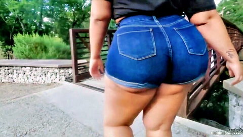 Simone Richards big booty in tight blue denim shorts walking outdoors