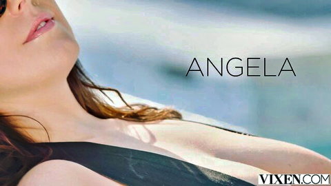 Angela White lounging in low-cut black swimsuit, showing deep cleavage