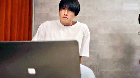 Asian man in white t-shirt caught watching mature JAV porn on laptop
