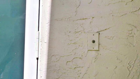 Mysterious stucco wall with doorbell in love-proof adult scene