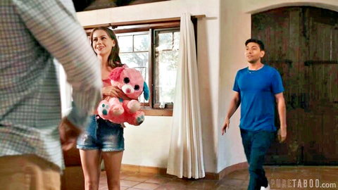 Selena Love in short denim shorts holding pink teddy bear with two men