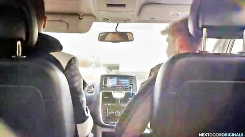 Two men in jackets viewed from back seat in SUV dashboard closeup