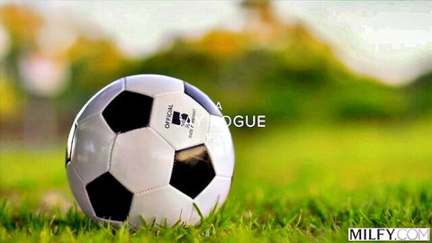 White soccer ball on green grass field with MILFY.com watermark, no nudity visible