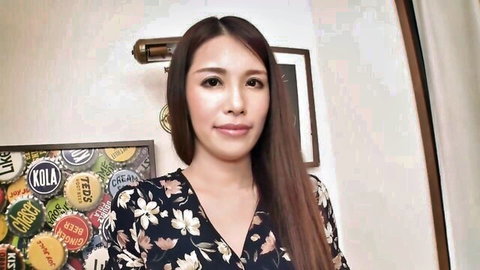 Smiling Japanese woman in floral wrap dress with long dark hair
