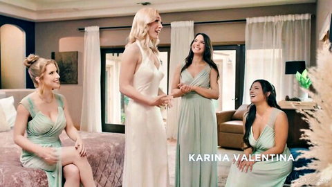 Sexy blonde bride in white dress with busty bridesmaids in green dresses posing in bedroom