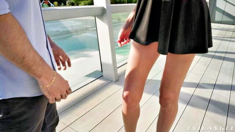 Rocco Siffredi with leggy babe in short black dress by pool