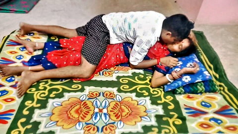 Indian man passionately kissing busty woman's neck in steamy foreplay on bed