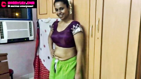 Curvy smiling Indian babe in tight sheer purple blouse showing big tits and low green petticoat