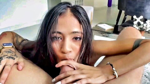 Petite tattooed Asian with tiny tits sucks cock while groped by hands in POV