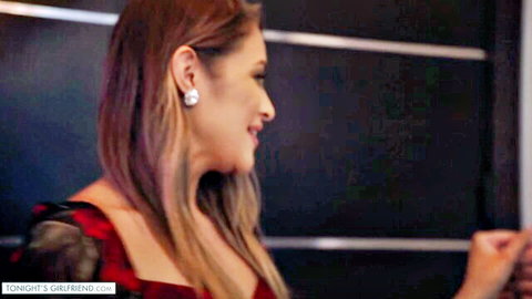 Gizelle Blanco smiling in sexy red dress, side profile view