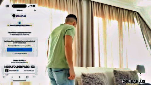 Clothed man in green shirt standing in bedroom with white curtains and bed in Telegram leak promo