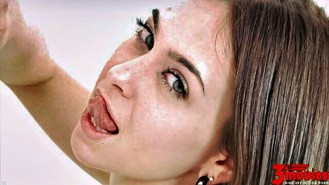Riley's freckled face with tongue out in seductive close-up from Mick Blue scene