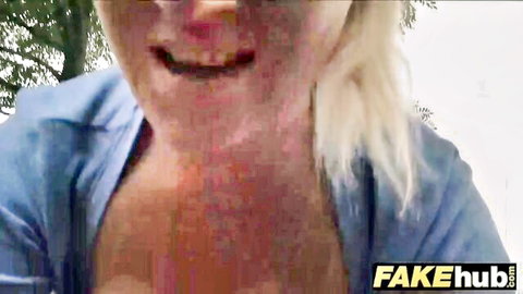 Blonde teen bimbo with huge boobies smiling outdoors in blue top
