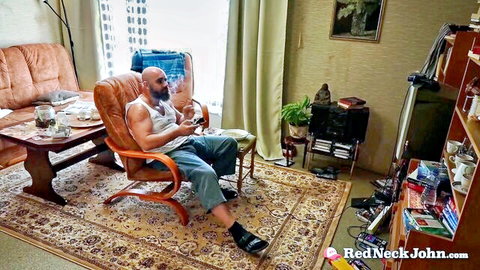 Redneck John muscular white guy smoking hookah in tank top and jeans