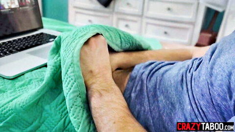 Boyfriend fingers girlfriend's pussy under green quilt on bed teasing orgasm